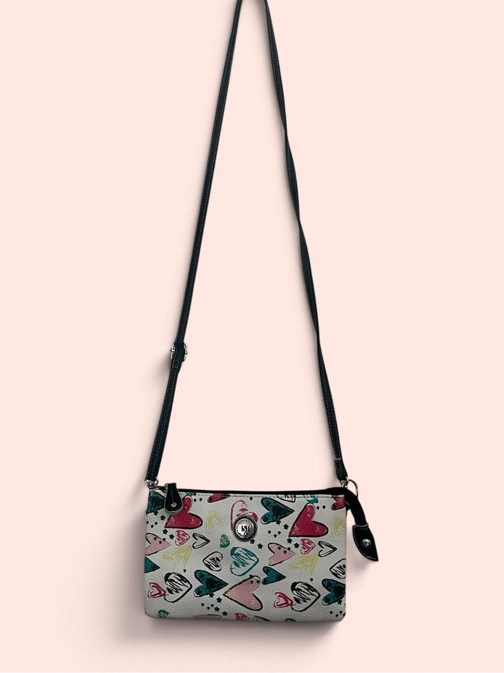 Stone & Co white crossbody bag with multi-colored heart print